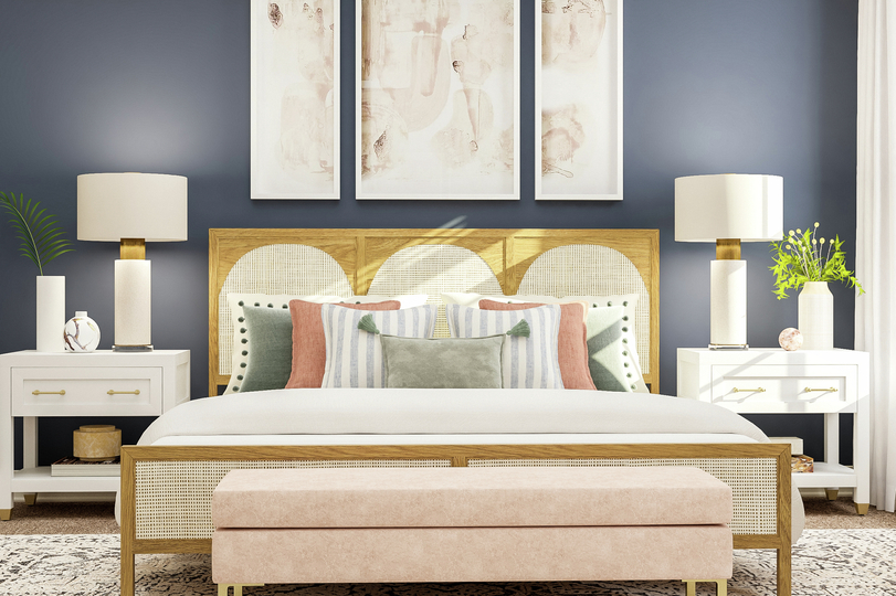 Rendering of spacious master bedroom with
  large wood framed bed and matching nightstands and decor along a blue accent
  wall with a view of the master bath to the left and beige carpet flooring
  throughout.