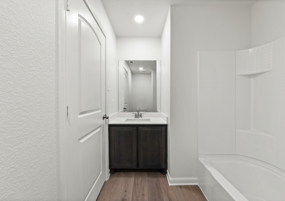 The secondary bathroom has a vanity space.