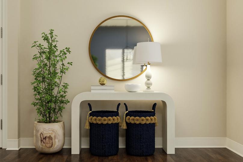 Rendering of an entryway showing a white
  entry table and dÃ©cor along a beige wall with dark wood look flooring
  throughout.