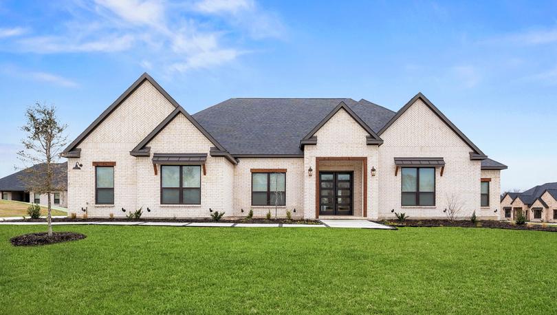 The Mantle II is a beautiful, one-story brick home with wood accents.