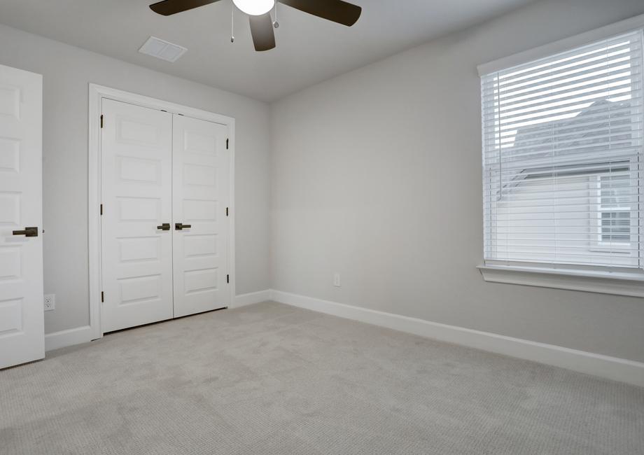 Secondary bedroom with a large closet and window.