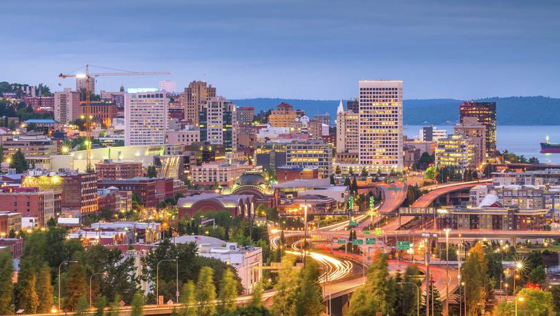 Tacoma, Washington at night with streaking lights on the freeway and lit windows on office buildings