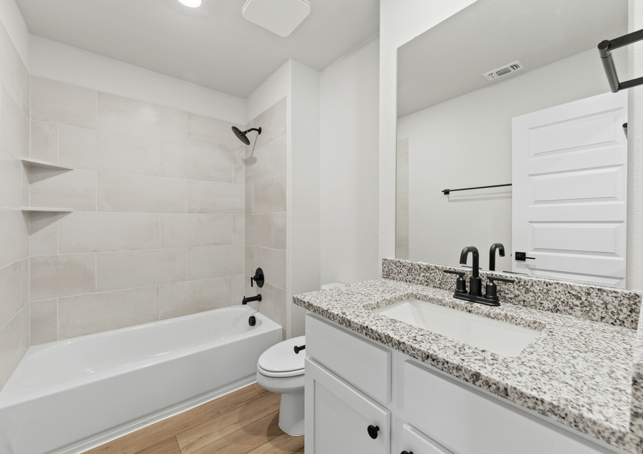 Secondary bathroom offers plenty of storage.