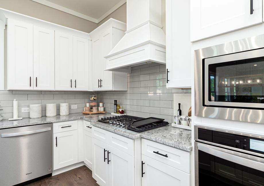 White cabinets, granite counter tops and stainless appliances.