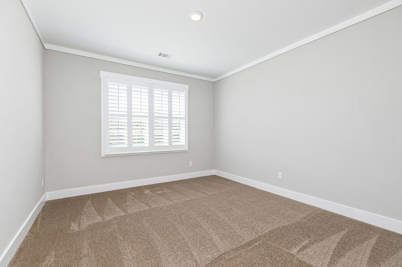 Secondary bedroom with carpet.