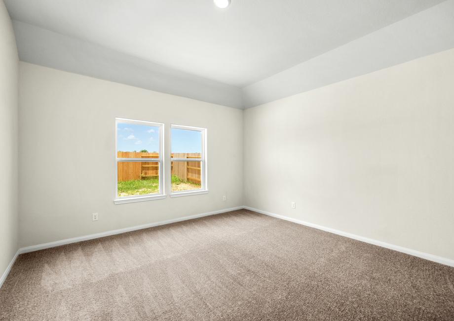 The master bedroom has a large window. 