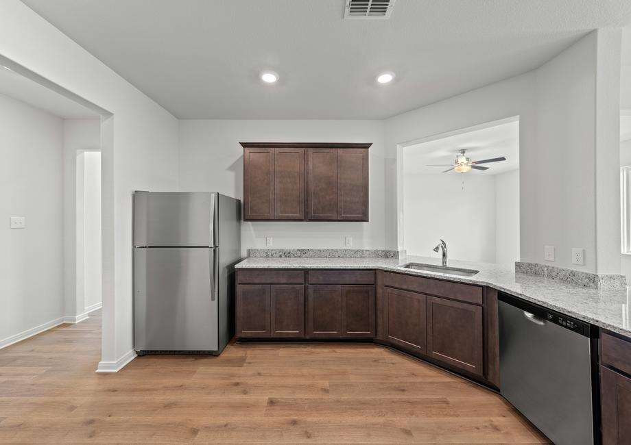 The kitchen has gorgeous wood cabinetry.