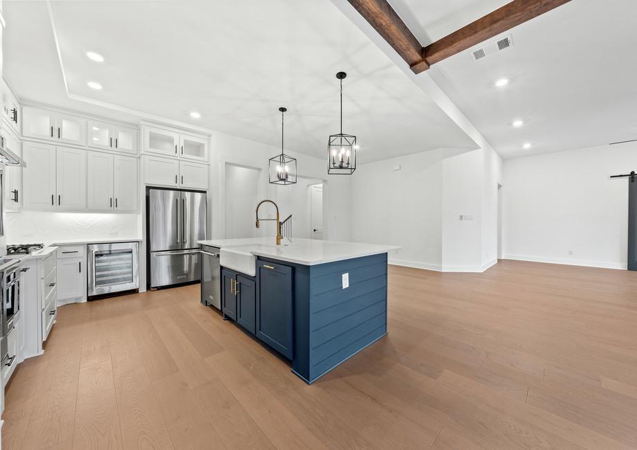 The kitchen has gorgeous white cabinetry with black hardware.