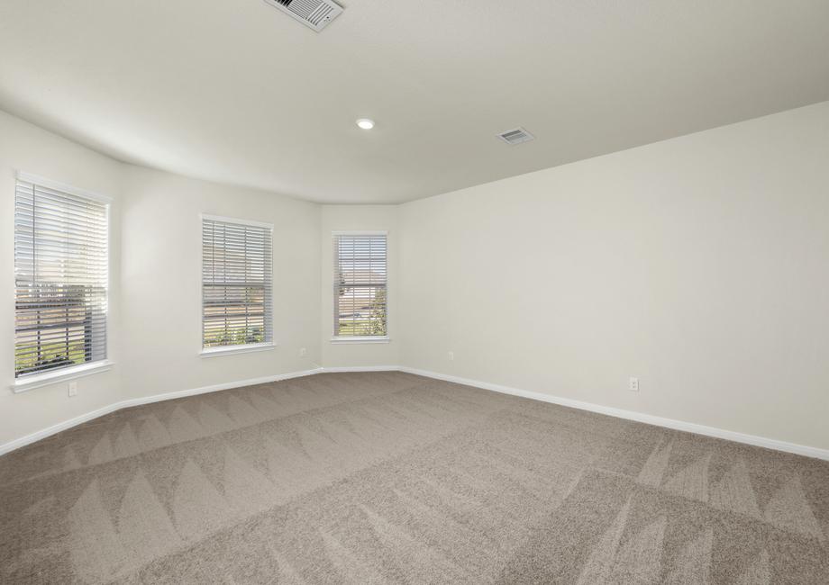 Windows let in plenty of natural light to this master bedroom.
