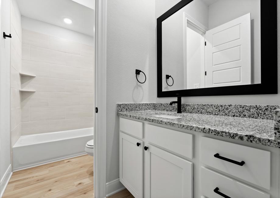 Fantastic secondary bathrooms with lots of storage.