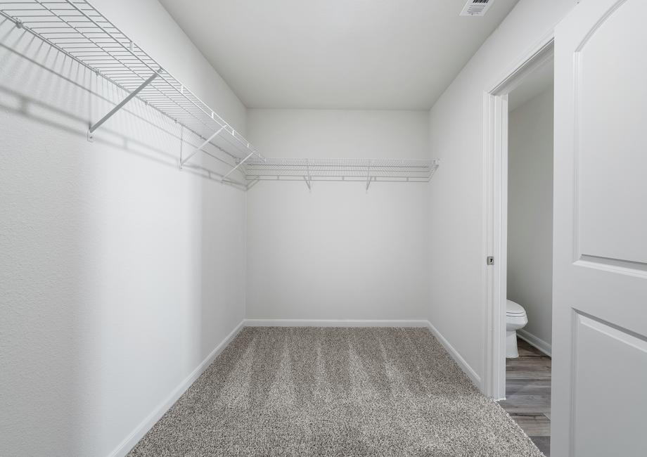 The walk-in closet in the master suite has plenty of room for clothes storage.