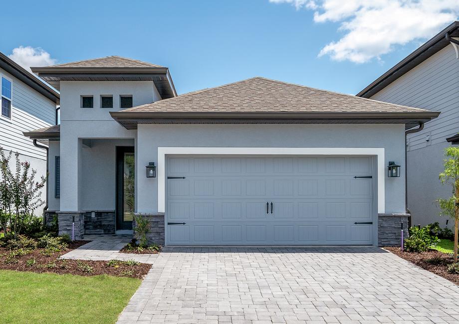 One-story home with stone detail, a covered front porch and a long driveway.