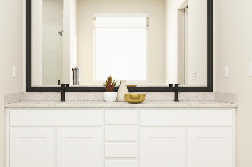 Rendering of the master bath with
  double-sink vanity. It has white cabinetry, matte black fixtures and a large,
  framed mirror.