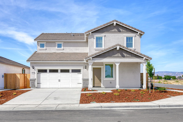 The Shelton is a beautiful two story home with stucco.