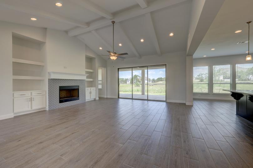 Spacious layout with the kitchen overlooking the expansive living room, featuring a fireplace.
