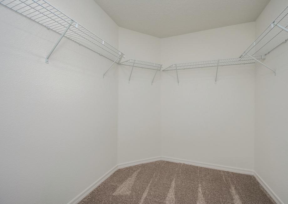 The walk in closet is spacious and ready for your wardrobe