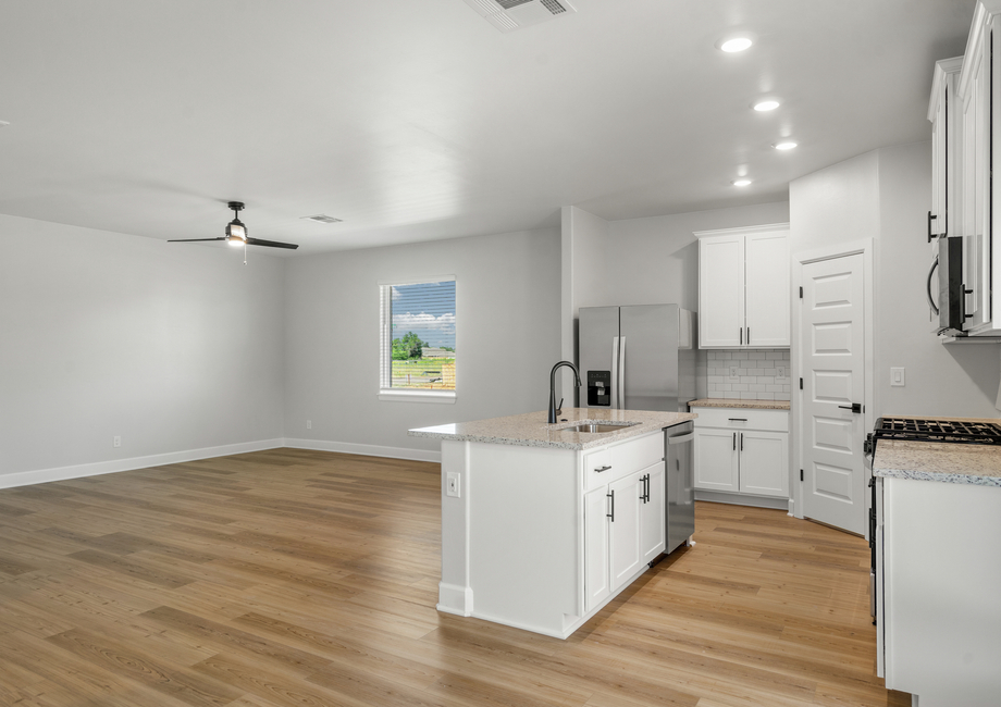 The kitchen and dining room look out into the family room.