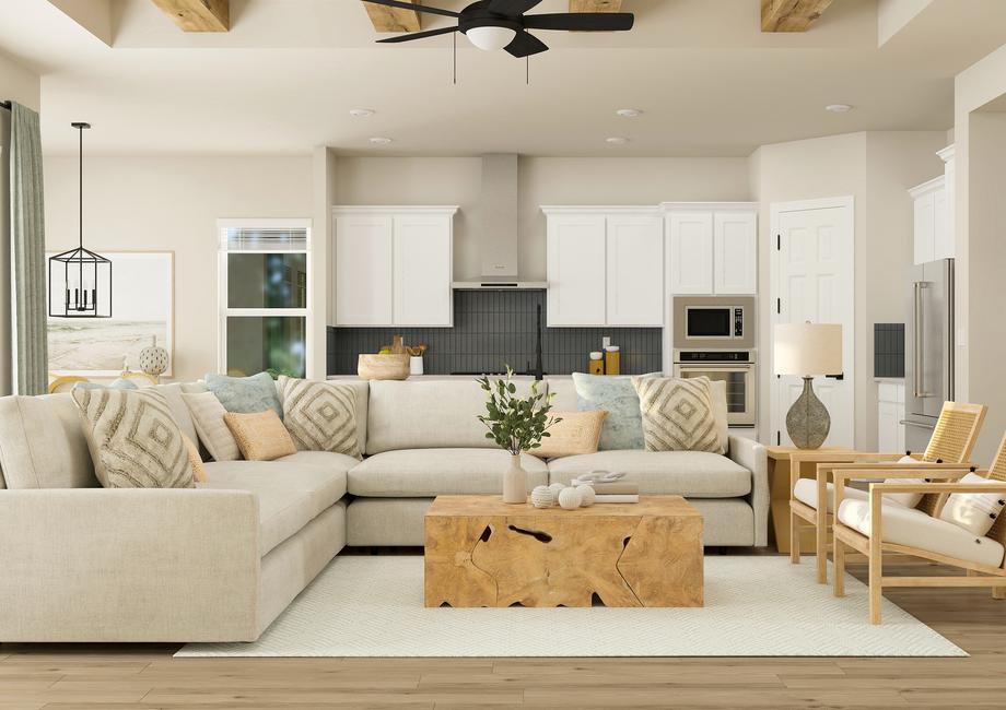 Rendering highlighting the open concept
  layout of the Laurel floor plan. The kitchen and dining room are against the
  back wall and the spacious living room is in the foreground.