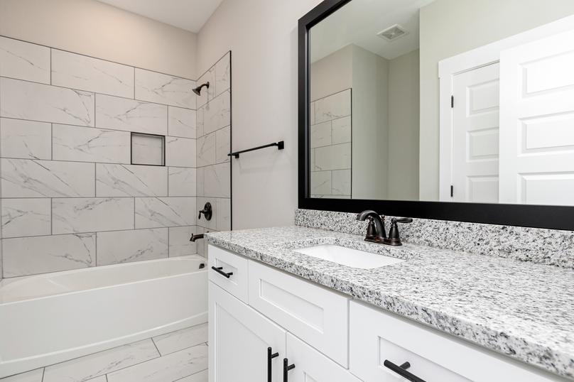 Secondary bathroom with a vanity and walk-in shower.