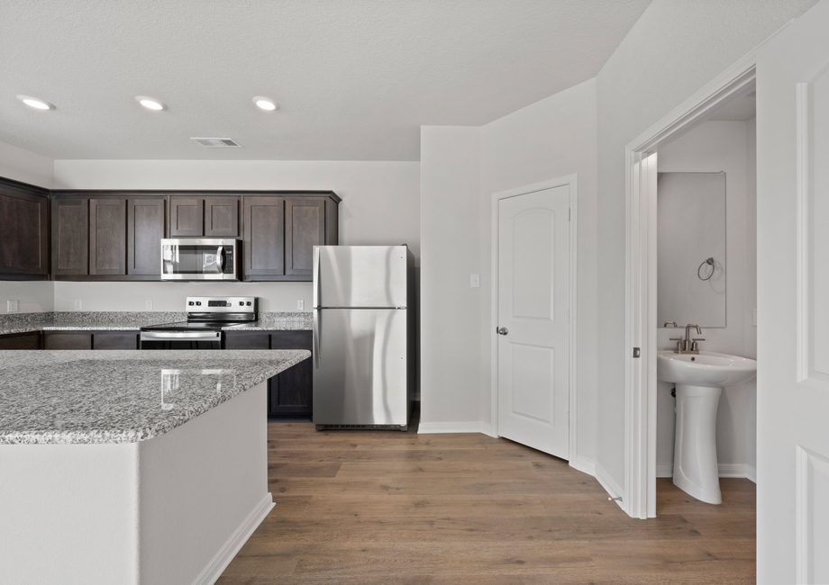 The powder room sits right off of the kitchen.