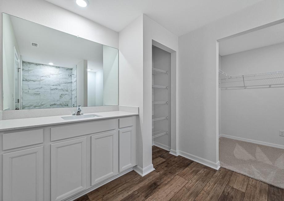 Beautiful bathroom with large vanity linen closet and walk in closet attached