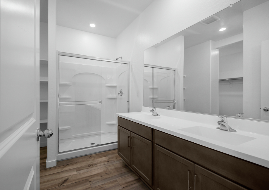 The master suite has a spacious glass shower and counterspace ideal for getting ready.