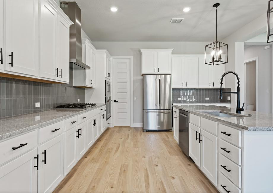 The chef-ready kitchen has stainless steel appliances.