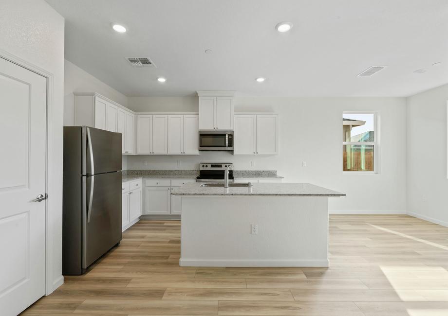 Enjoy stunning countertops and designer wood cabinetry in this kitchen.