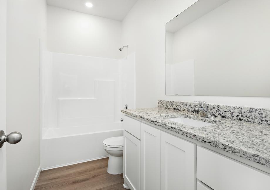 The bathroom has a shower/tub combo.