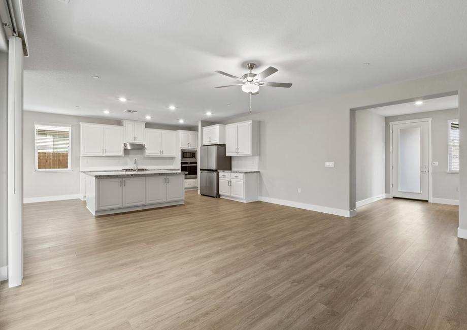 The kitchen features bright white cabinetry.