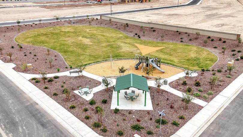 This park offers green space, a playground, a shade ramada, and park benches.