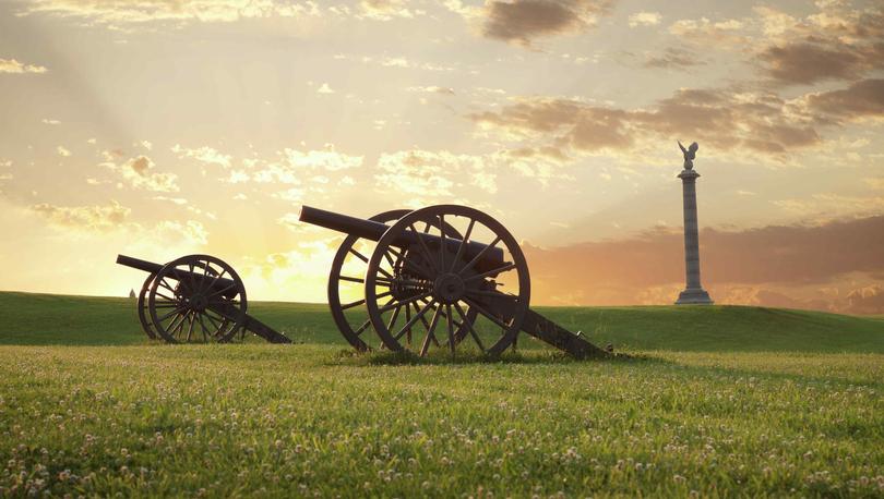 Sharpsburg, Maryland Antietam National Battlefield showing two cannons on grassy field with monument in the background