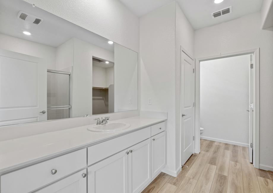 The master bath has a private commode and tons of drawer space.
