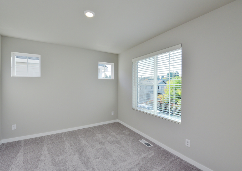 The master bedroom is spacious with lots of natural light.