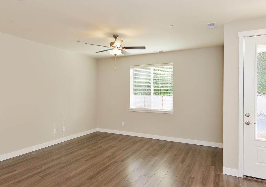 The family room is spacious with a ceiling fan.