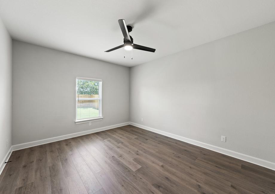 The master bedroom of the Sabine floor plan is spacious and has a window.