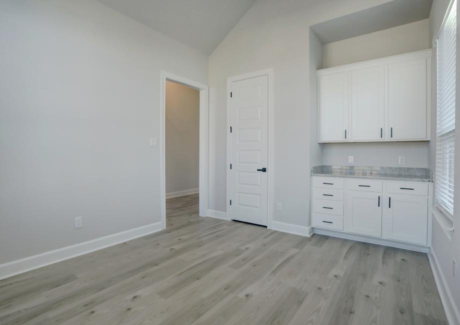 Study off of the entry with extra cabinet space paired with a storage closet.