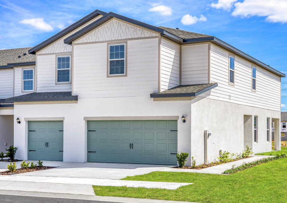 The Destin plan with exterior landscaping and a two-car garage