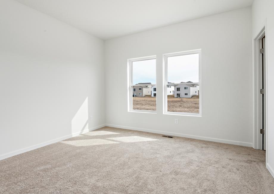 The master bedroom is spacious and has a large window.