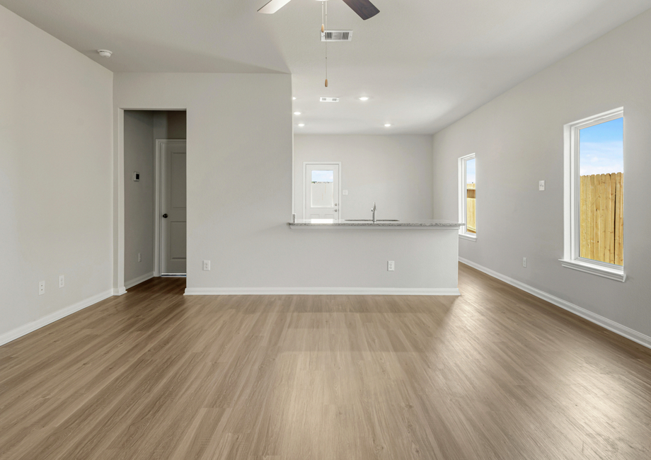 A breakfast bar in the kitchen overlooks the family room