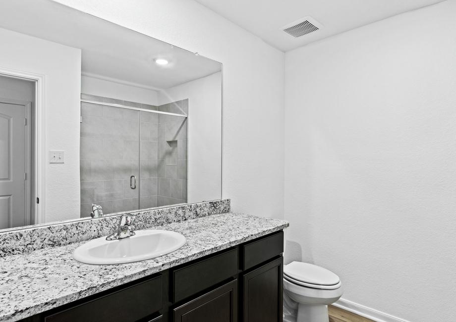 Master bathroom with a tile-lined walk-in shower.