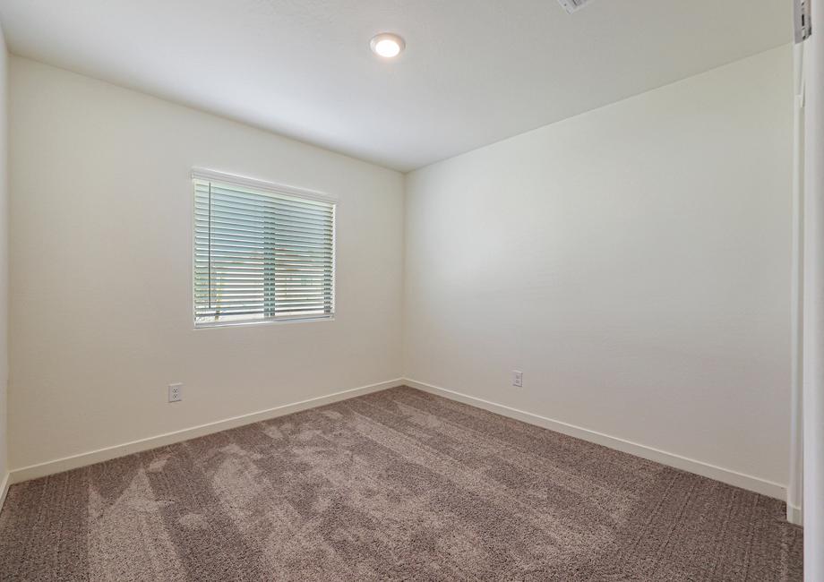 Windows let in plenty of light to this secondary bedroom.