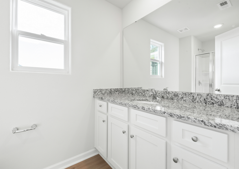 The master bathroom has a glass-enclosed shower