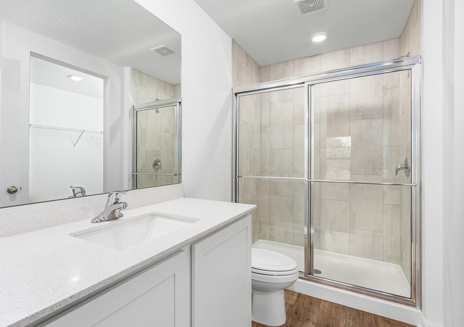 The master bathroom has a walk-in shower with sliding doors.