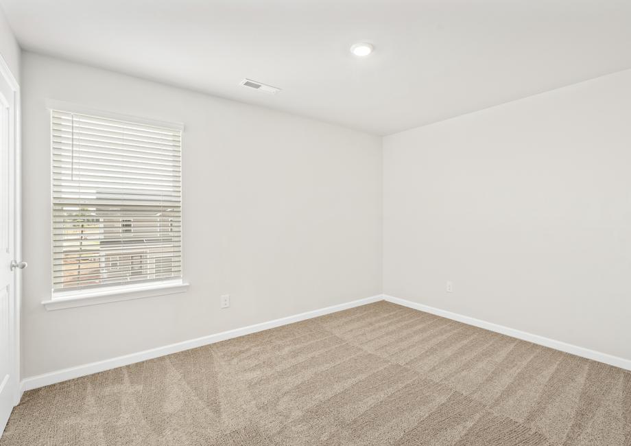 Each of the secondary bedrooms includes the tan carpets, closets and bright windows