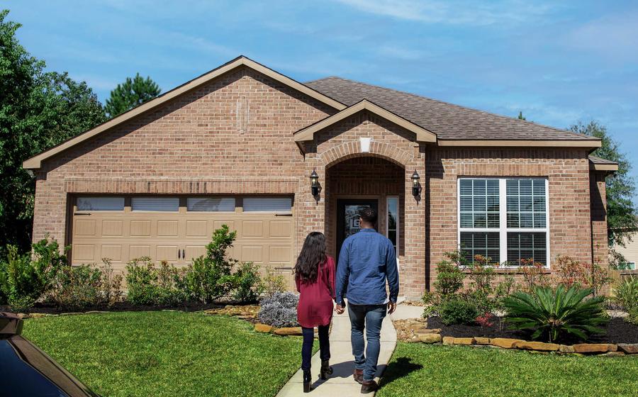 Couple walking to front door of LGI Homes Sales Office