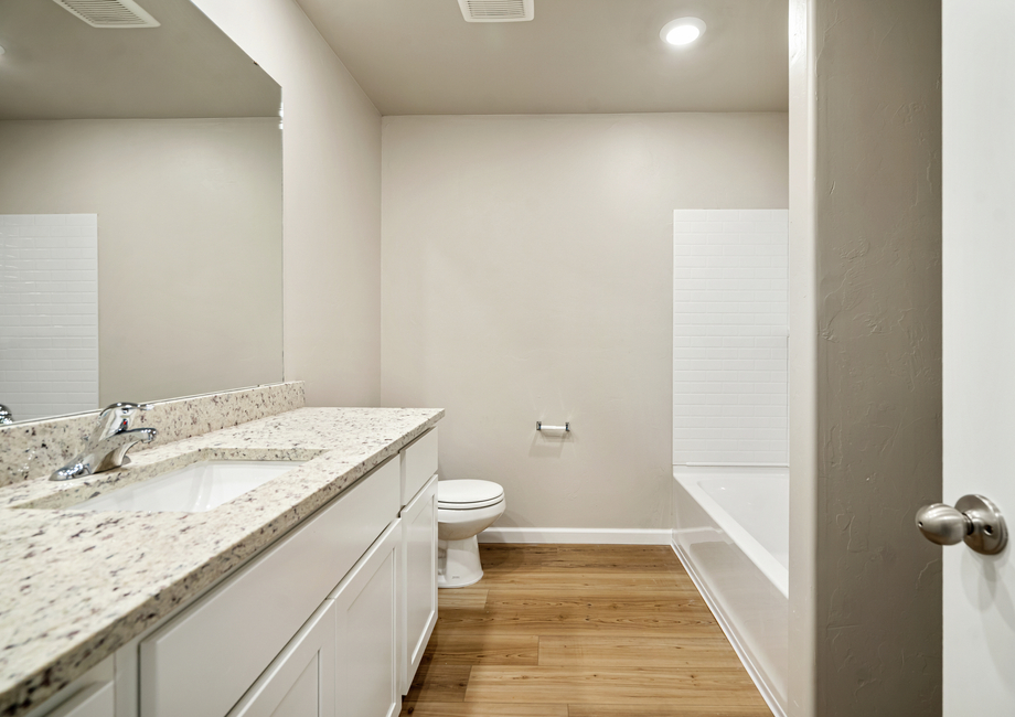 The secondary bathroom features a shower-tub combo.