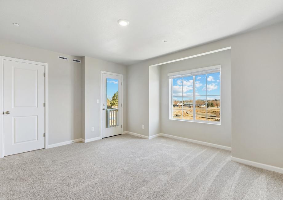 The master bedroom has a window inlet and a door to an outside deck.