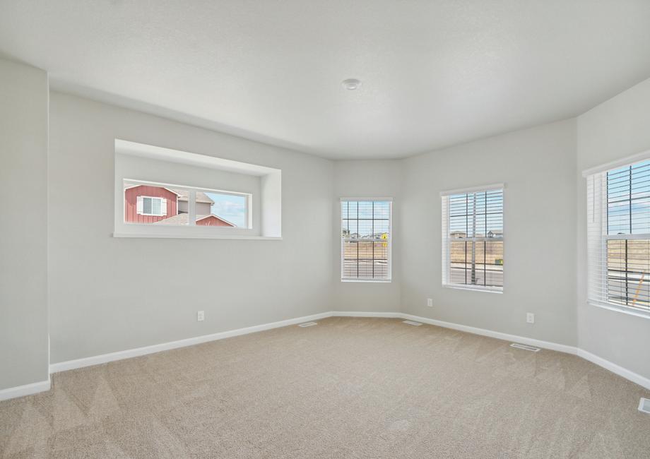 The master bedroom is spacious with bay windows.