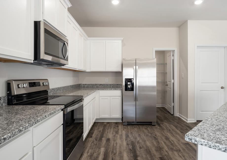The kitchen in the Allatoona includes stainless steel appliances